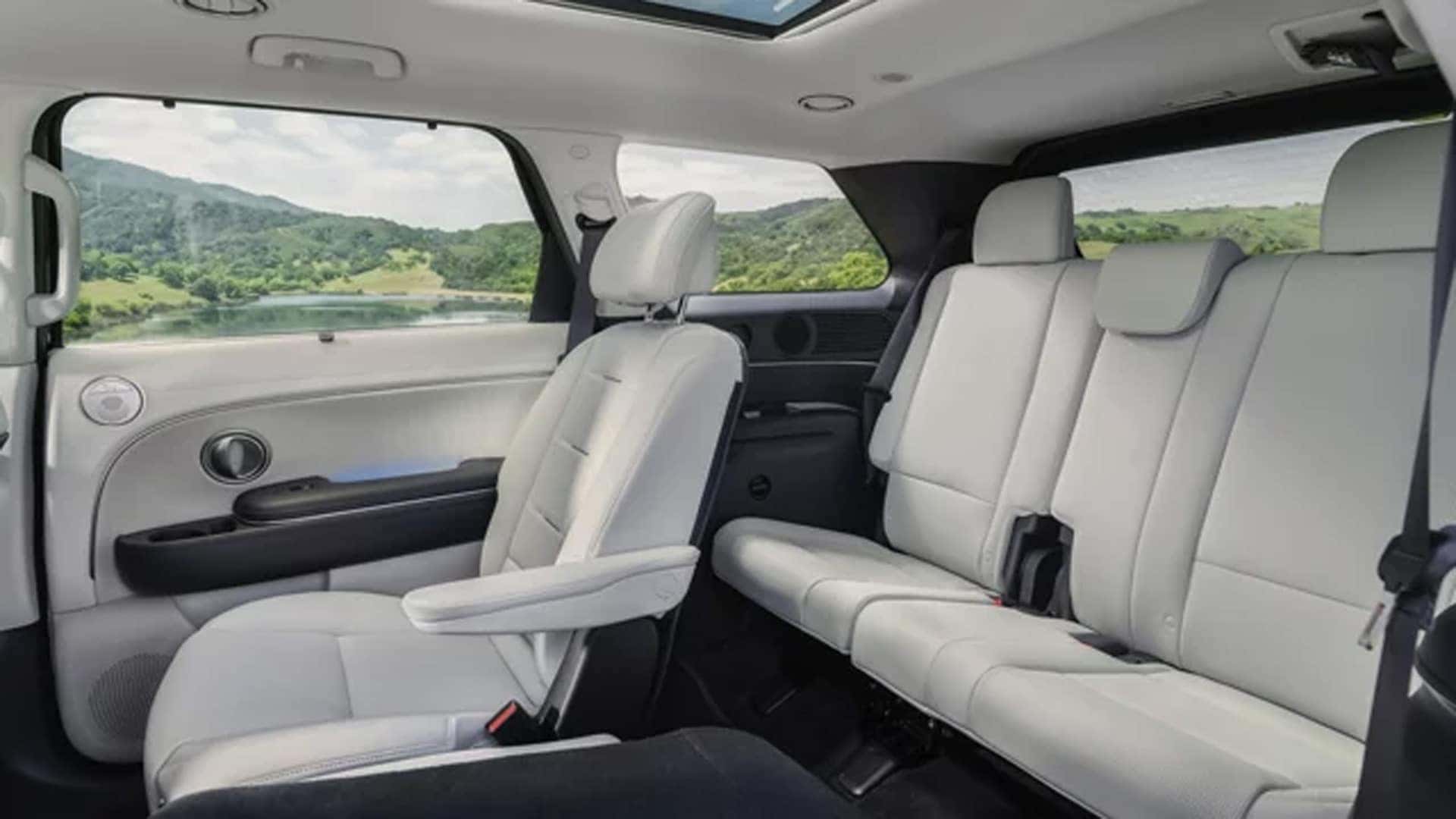 2026 Hyundai Palisade Hybrid interior showing second and third row seating with spacious legroom and panoramic roof