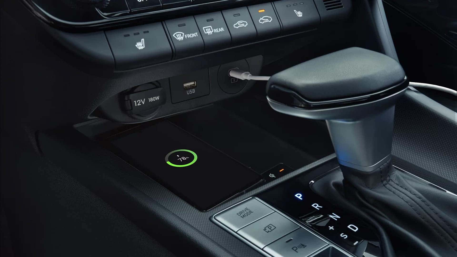 Center console of the 2026 Hyundai Elantra showing gear selector, drive mode buttons, USB ports, and wireless charging pad
