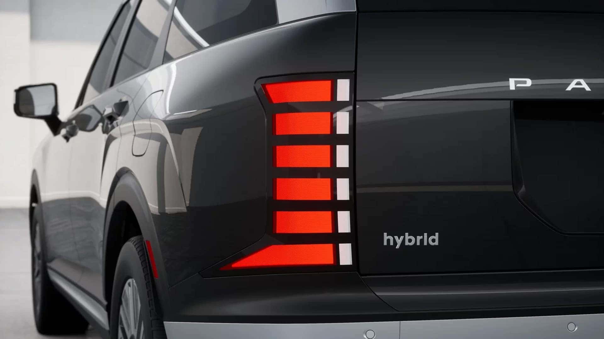 Rear exterior detail of the 2026 Hyundai Palisade Hybrid displaying the taillight design and hybrid badging