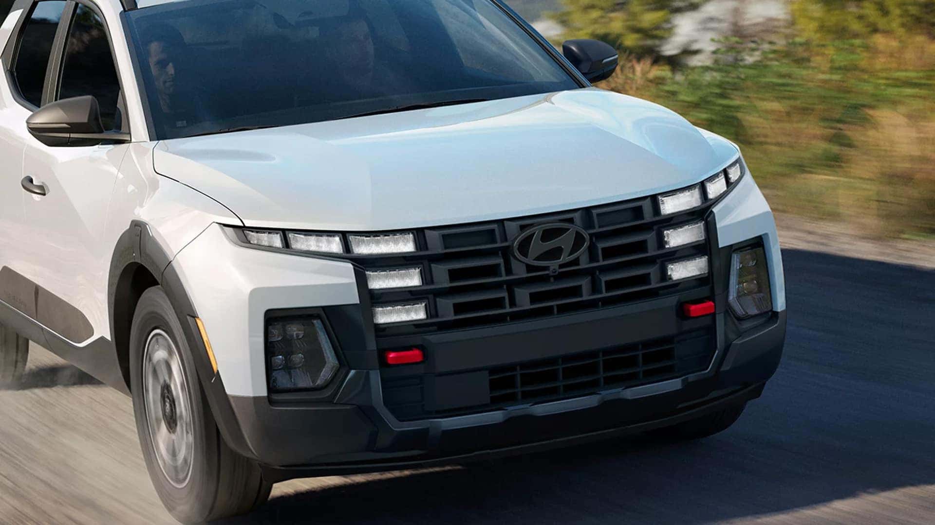 Front exterior close-up of the 2026 Hyundai Santa Cruz showing grille design, LED lighting, and rugged trim details