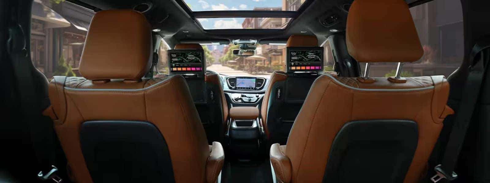 2026 Chrysler Pacifica interior with dual rear seat entertainment screens, panoramic sunroof, and premium leather seating