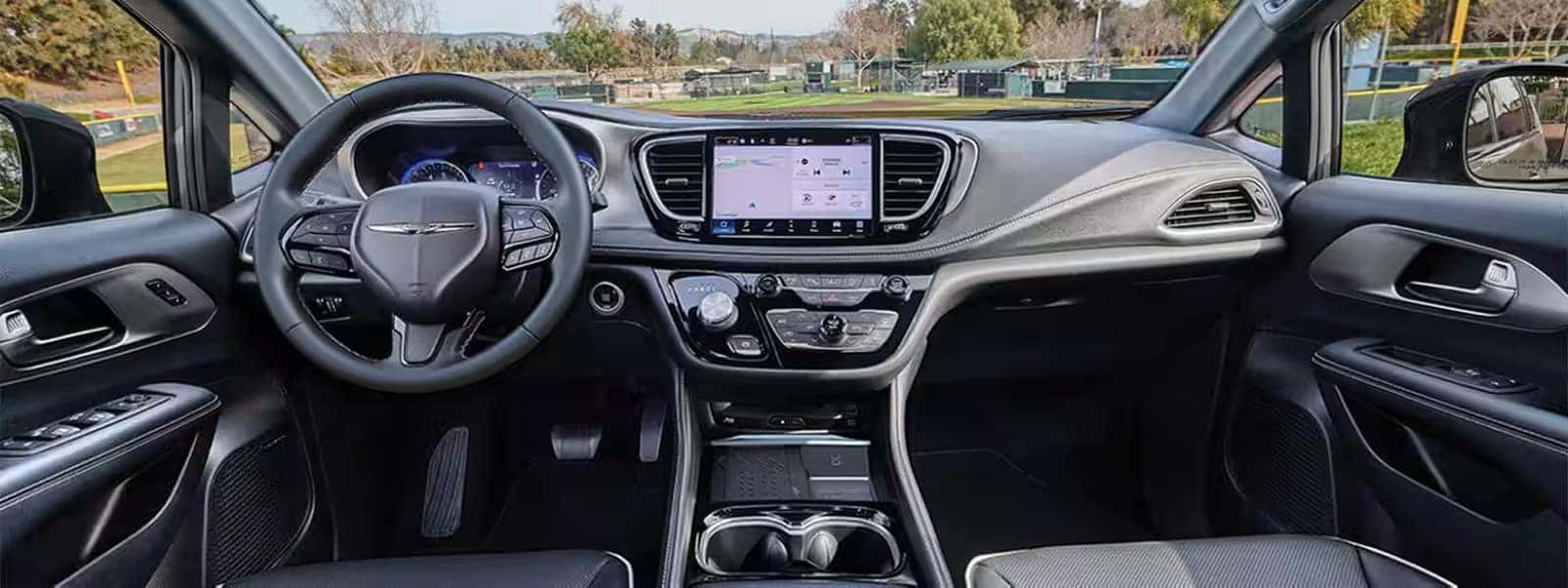 Interior view of the 2026 Chrysler Pacifica showing Uconnect 5 touchscreen, digital driver display, and modern dashboard layout