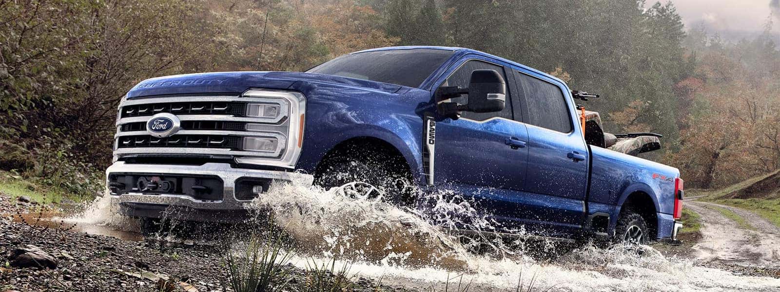 2026 Ford F-250 Super Duty driving through a shallow stream, showcasing heavy-duty capability, four-wheel drive performance, and rugged exterior design