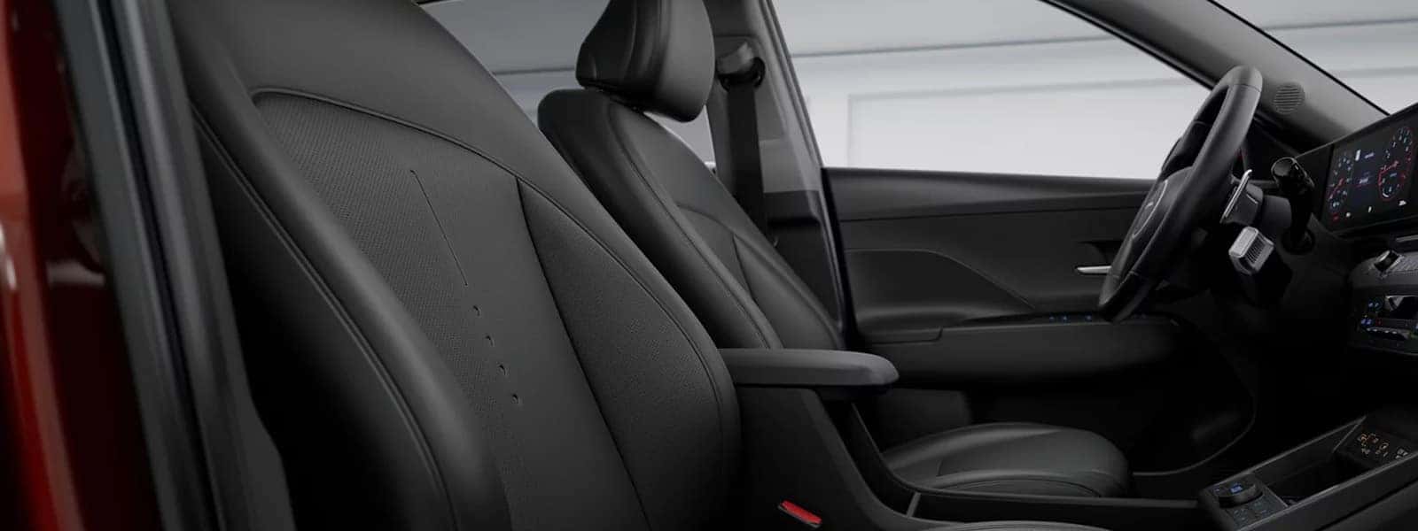 Front seats of the 2026 Hyundai Kona interior showing supportive seating, center armrest, and modern cabin layout