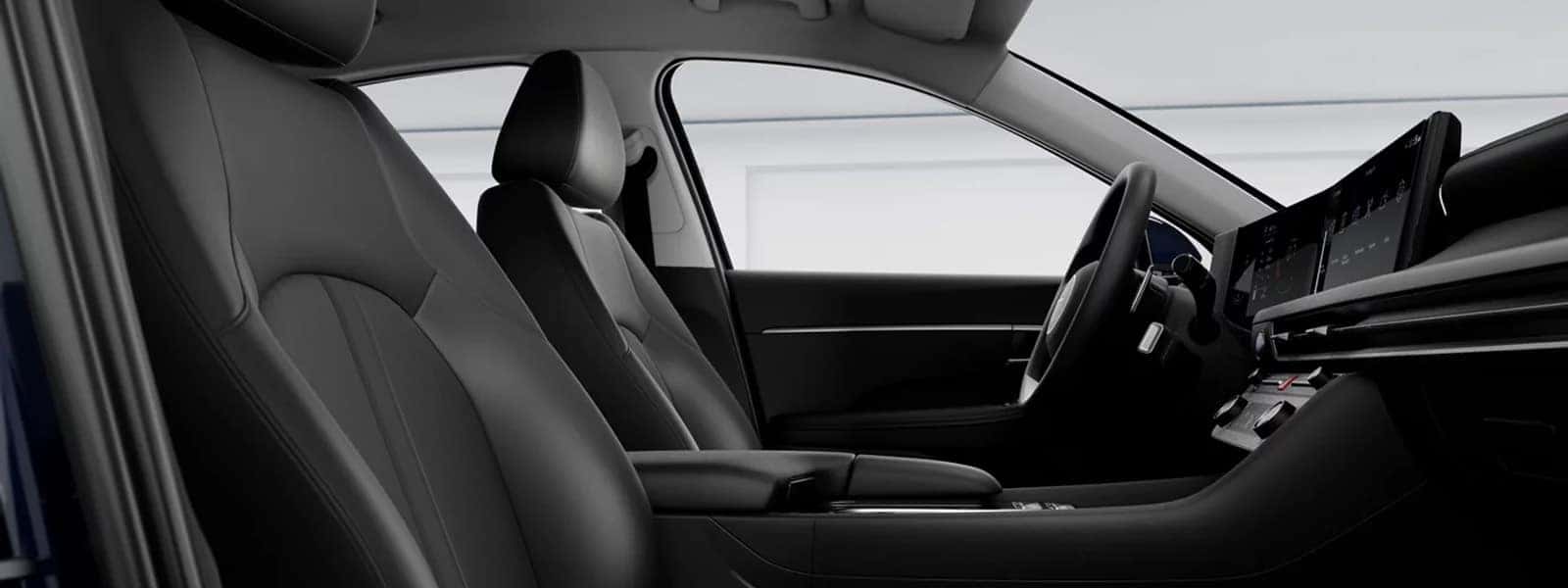Driver and front passenger seats inside the 2026 Hyundai Sonata Hybrid with center console, wide digital display, and modern dashboard layout