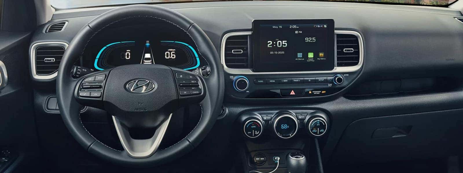 Interior view of the 2026 Hyundai Venue showing the steering wheel, digital instrument cluster, center touchscreen display, and climate controls.