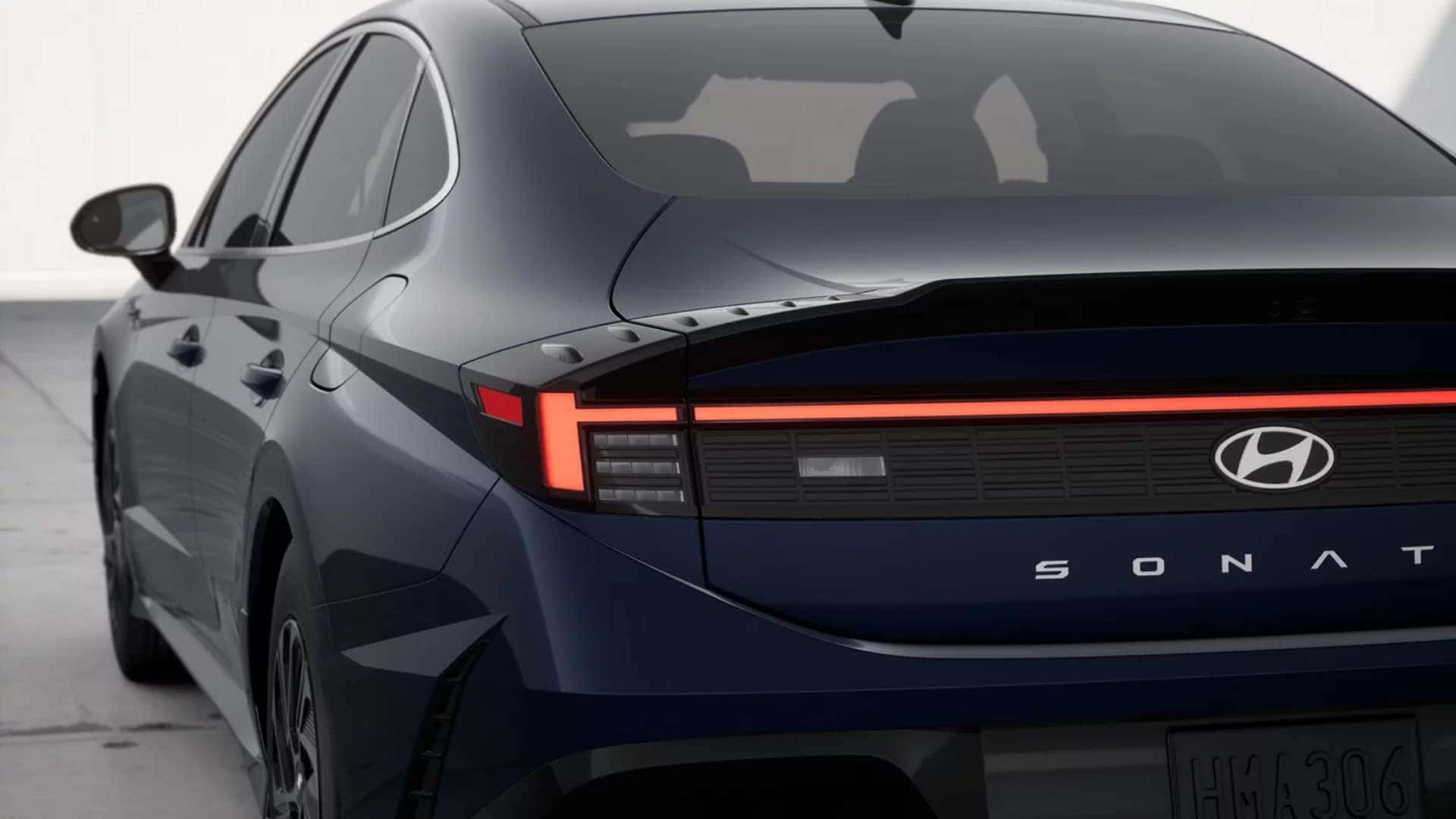 Rear three quarter view of the 2026 Hyundai Sonata Hybrid highlighting full width LED taillight bar, SONATA badging, and sculpted hybrid sedan design