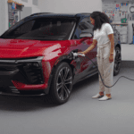 Chevy Blazer EV parked in a garage while plugged into a wall mounted home charging station with cable connected
