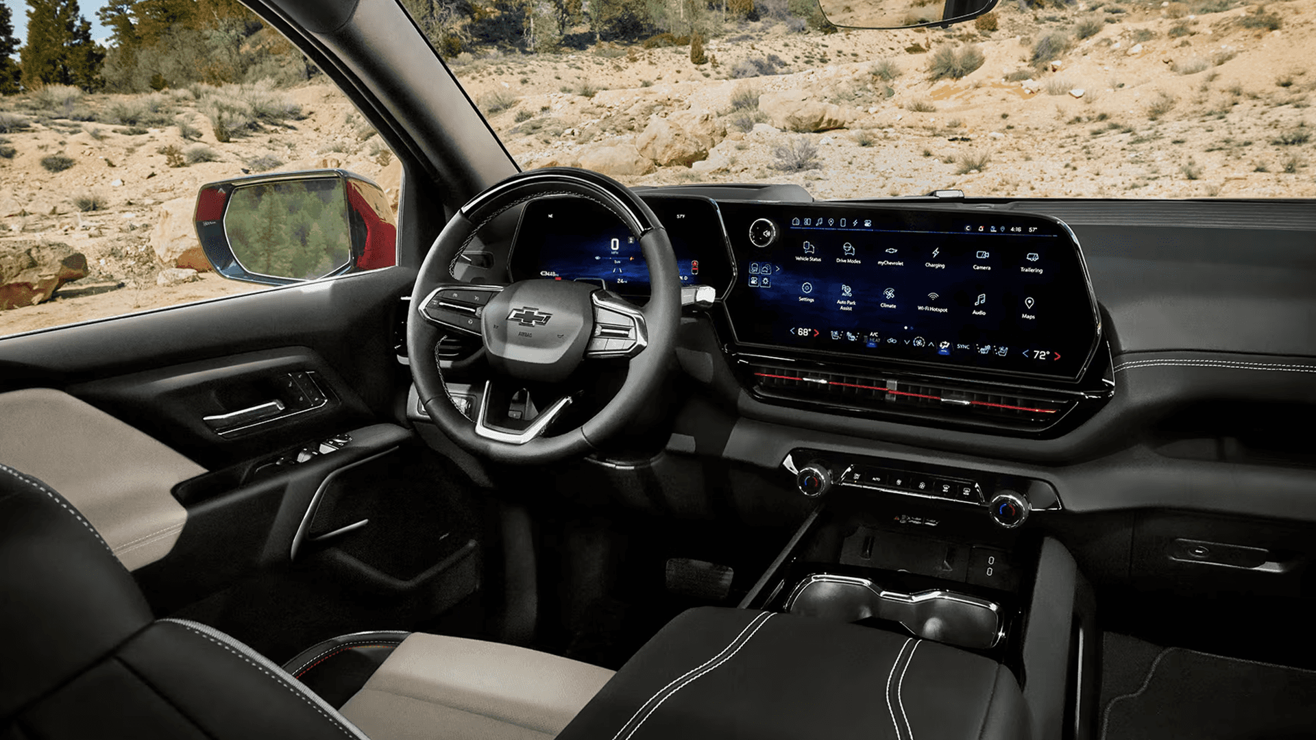 Silverado EV interior with wide touchscreen showing Google Assistant and vehicle apps beside steering wheel