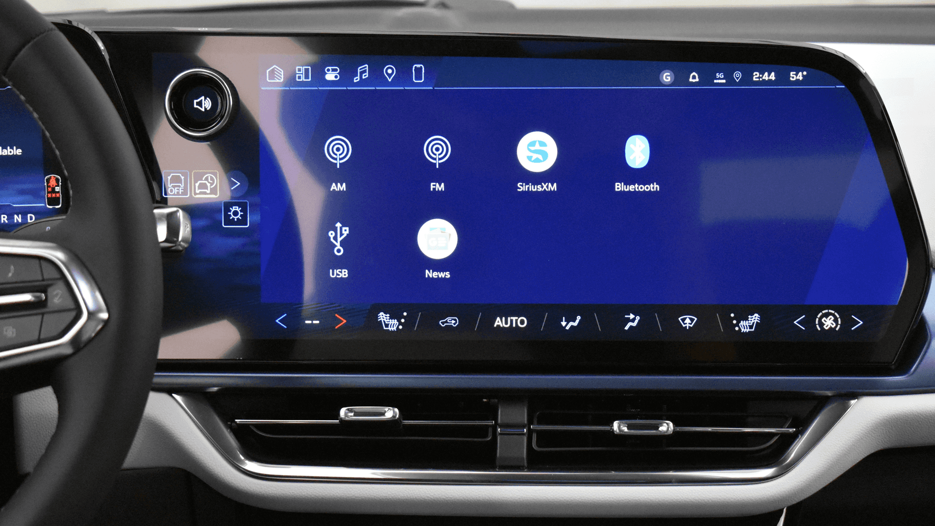 Close-up of Equinox EV infotainment touch-screen showing audio sources like AM, FM, SiriusXM, Bluetooth, and USB