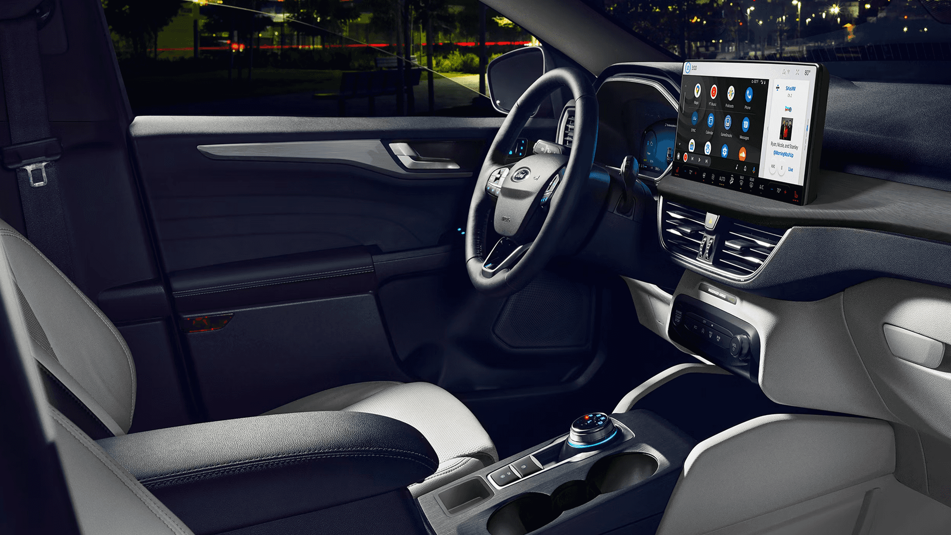 Front cabin of 2026 Ford Escape with wide touchscreen, digital cluster, rotary dial shifter, and two tone seats