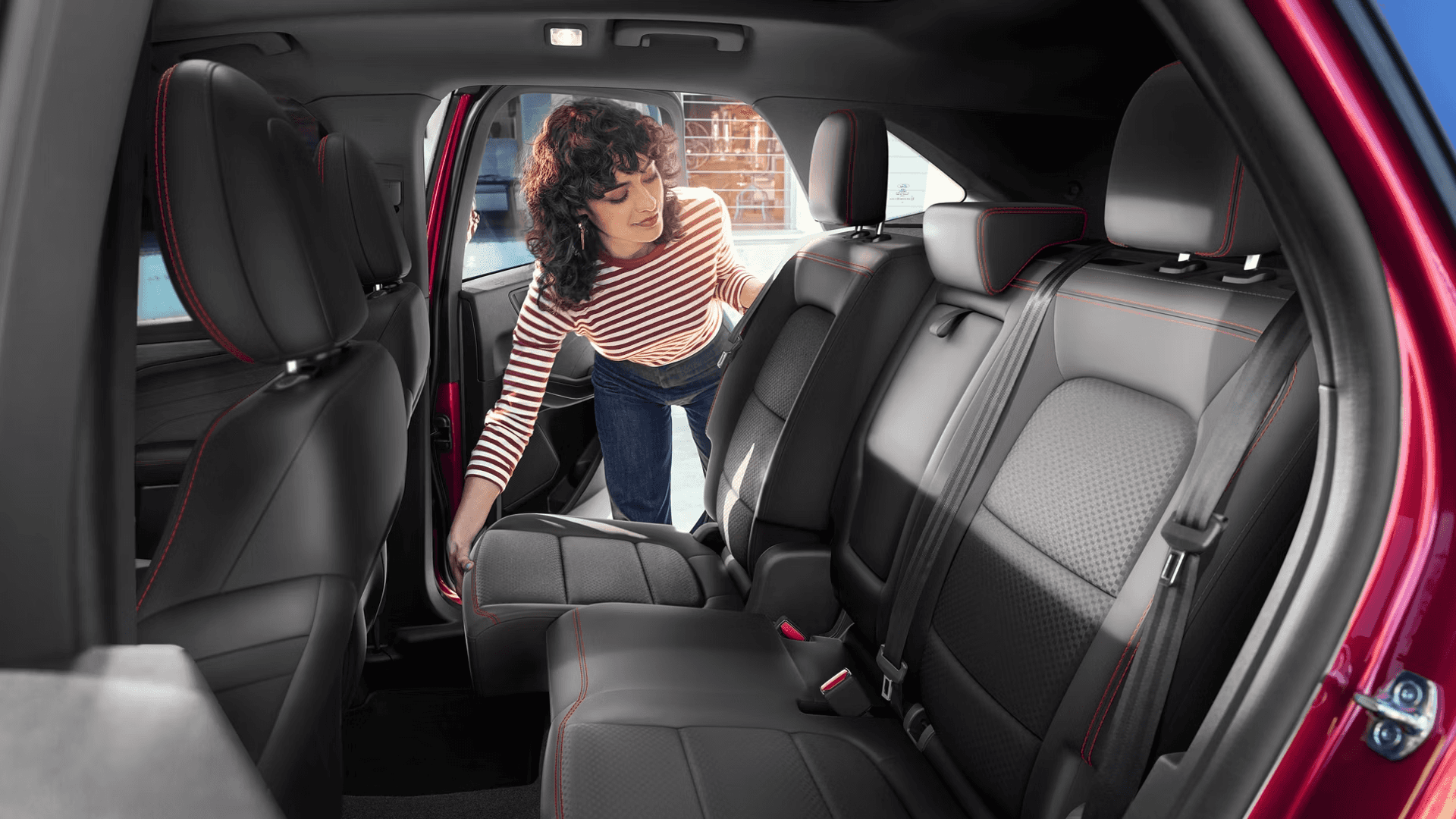 Driver adjusts sliding second-row seat in 2026 Ford Escape, highlighting rear legroom flexibility