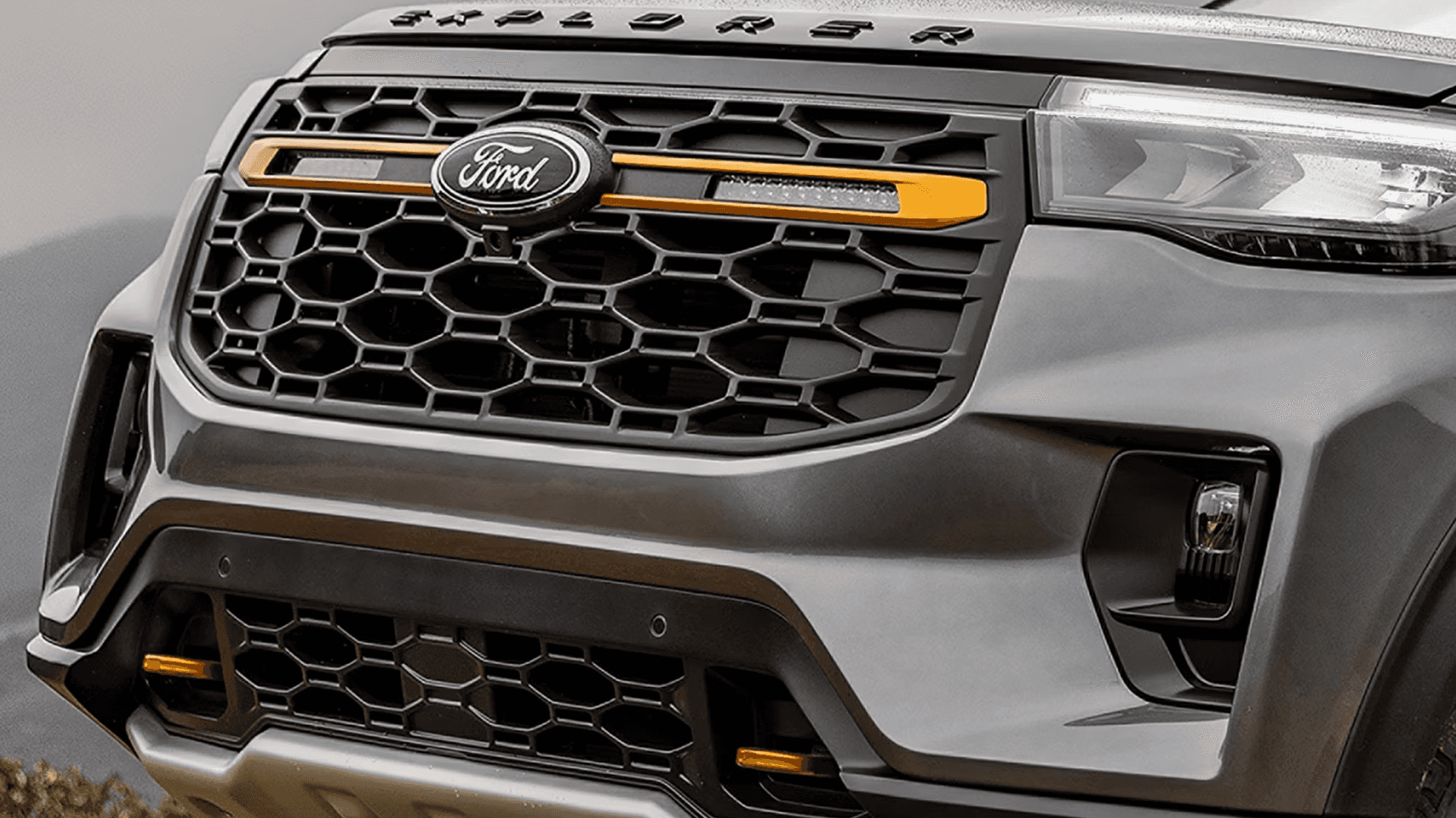 Close-up of 2026 Ford Explorer Tremor grille with amber accents and rugged front fascia