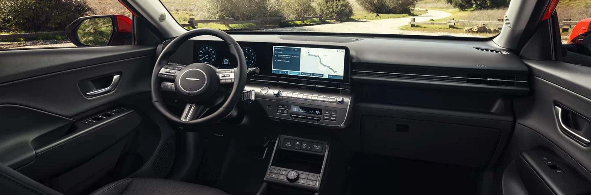 Interior view of the 2026 Hyundai Kona Hybrid showing the dashboard, steering wheel, digital instrument cluster, and center touchscreen display.