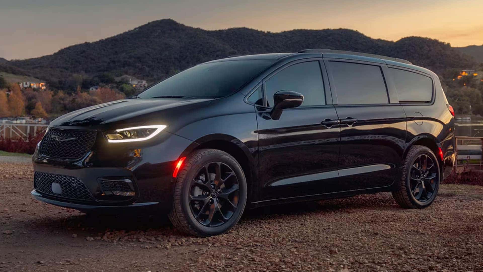 Black 2026 Chrysler Pacifica at sunset showing LED headlamps, daytime running lights, and sculpted front fascia