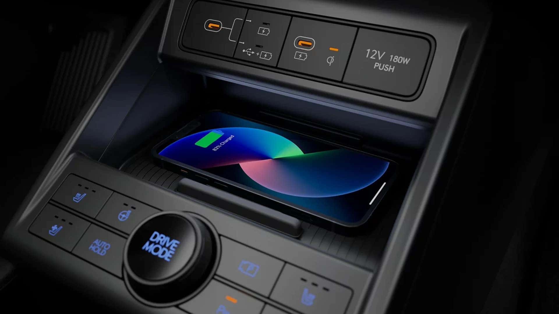 Wireless smartphone charging pad and USB ports in the 2026 Hyundai Kona center console with a device charging inside the tray