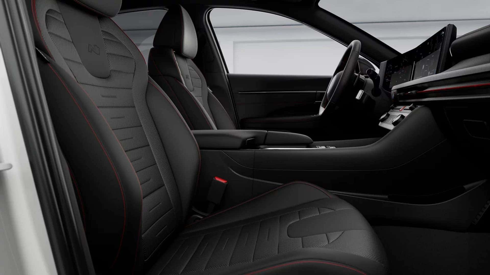 Front seating area of the 2026 Hyundai Sonata showing contoured sport seats, center console storage, and a driver focused interior layout