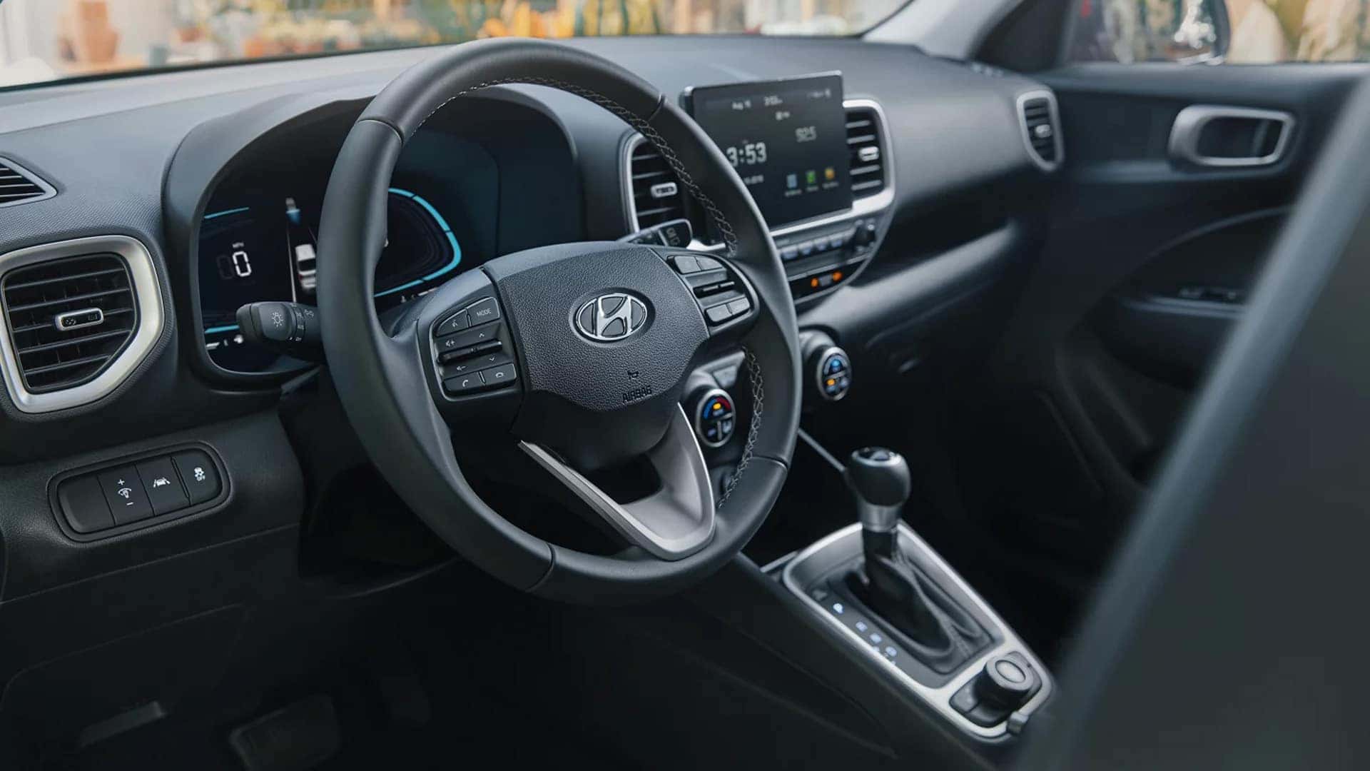 Driver’s view of the 2026 Hyundai Venue interior with steering wheel controls, instrument cluster, and center touchscreen display.