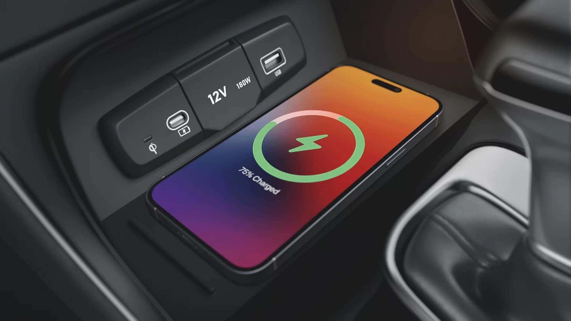 Wireless smartphone charging pad and USB ports in the 2026 Hyundai Venue center console with a device charging.