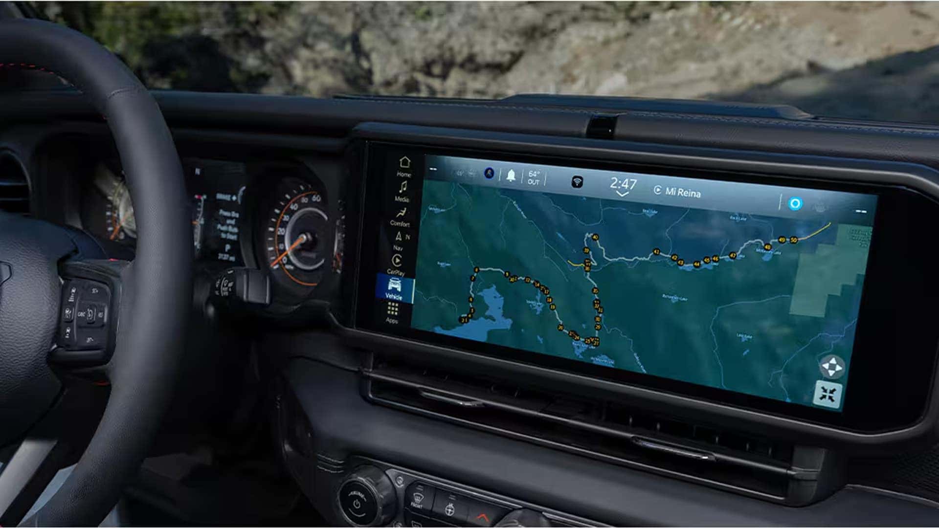 Wide interior view of the 2026 Jeep Gladiator touchscreen showing Uconnect 5 NAV with detailed off-road trail mapping and route tracking