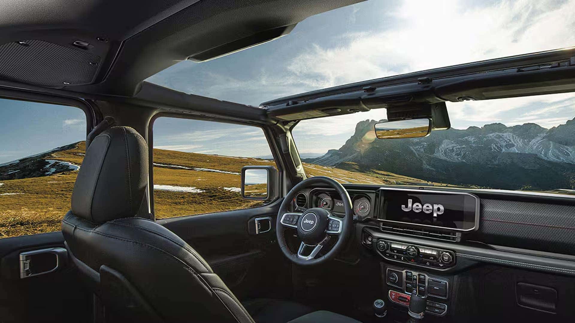 2026 Jeep Wrangler interior with open roof panels removed, showing dashboard layout and front seating