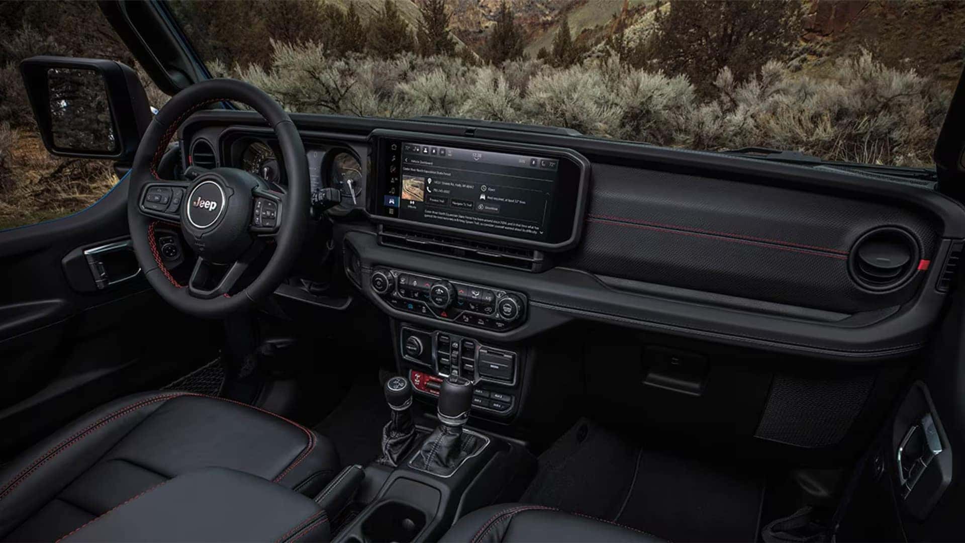 2026 Jeep Wrangler dashboard with 12.3-inch Uconnect 5 touchscreen displaying navigation and Off-Road Pages interface