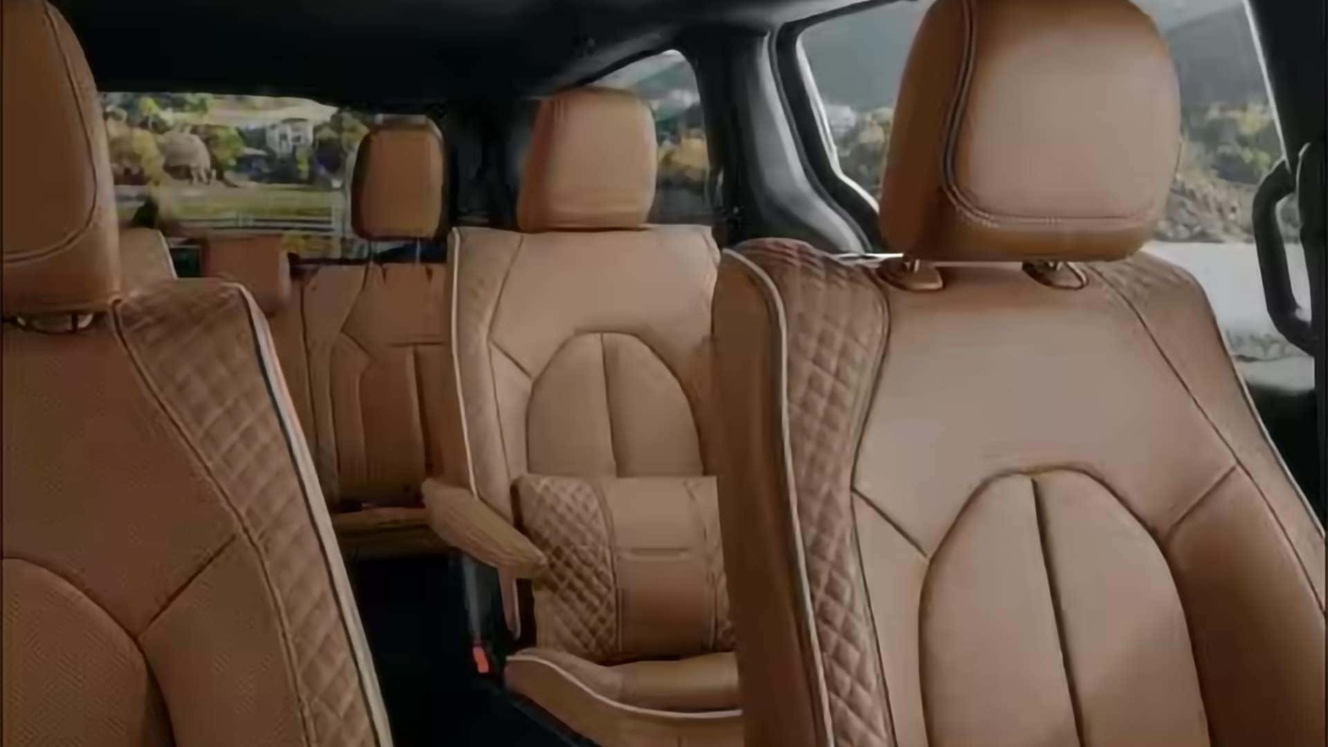 2026 Chrysler Pacifica interior with tan leather seating, second row captain’s chairs, and third row seats visible
