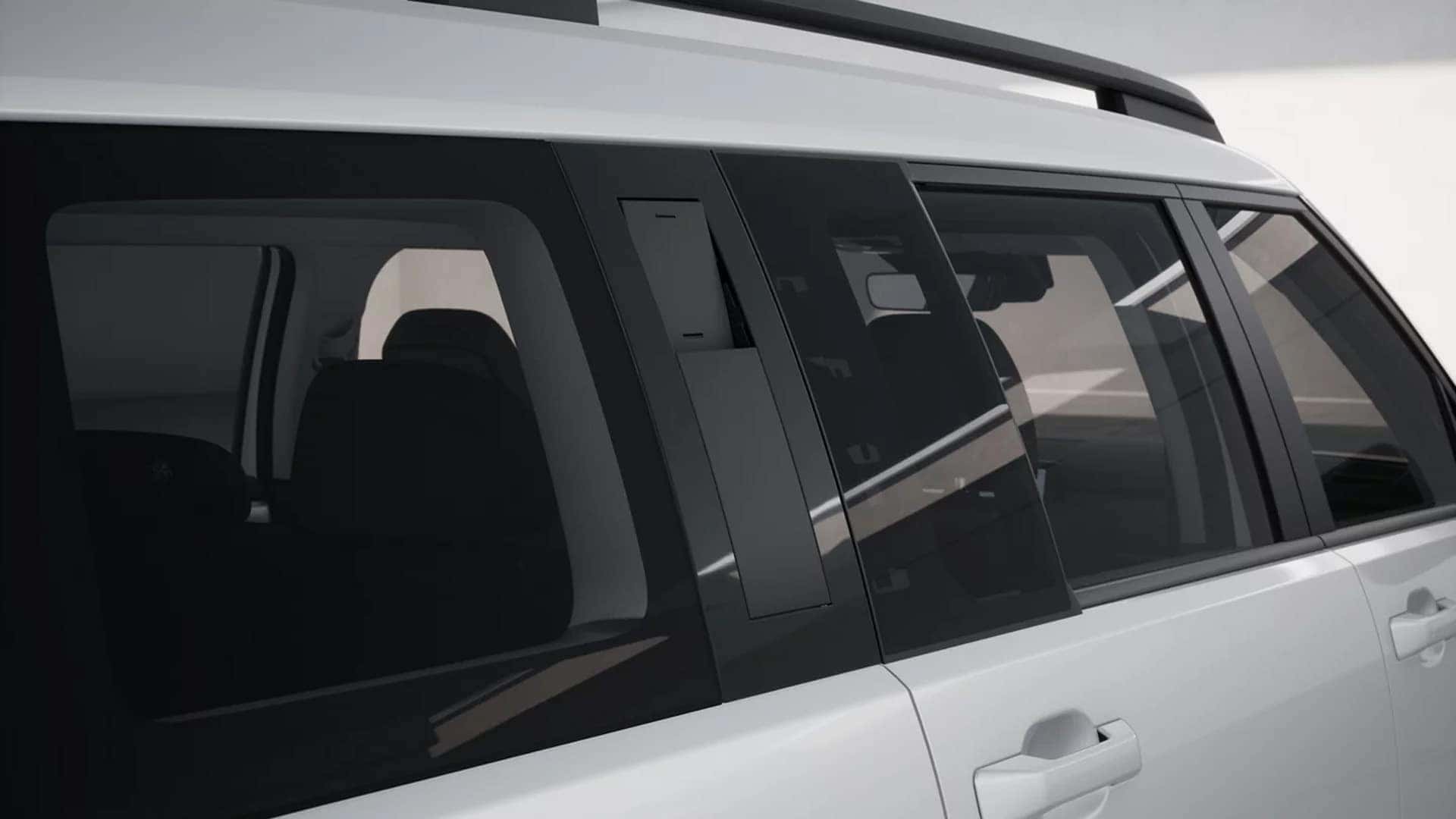 Side view of a white 2026 Hyundai Santa Fe showing roof rails, tinted windows, black body cladding, and straight-edged SUV design.