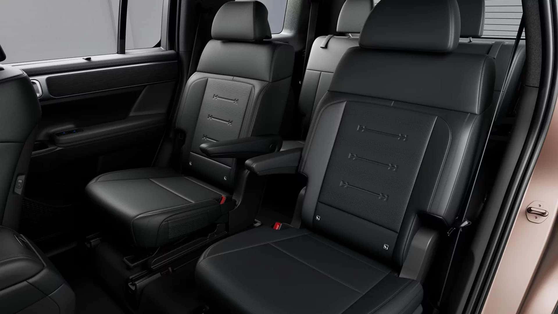 Front seating area of the 2026 Hyundai Santa Fe interior showing supportive seats, center armrest, and spacious legroom