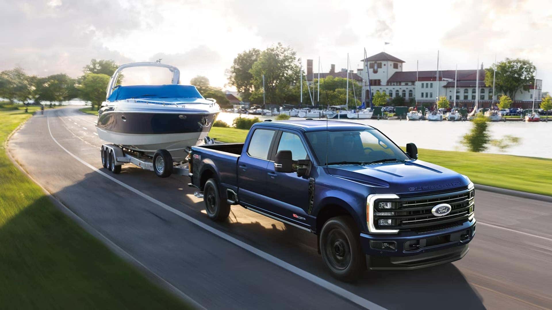 2026 Ford F-250 Super Duty towing a large boat on a trailer, demonstrating heavy-duty towing capability and stable highway performance