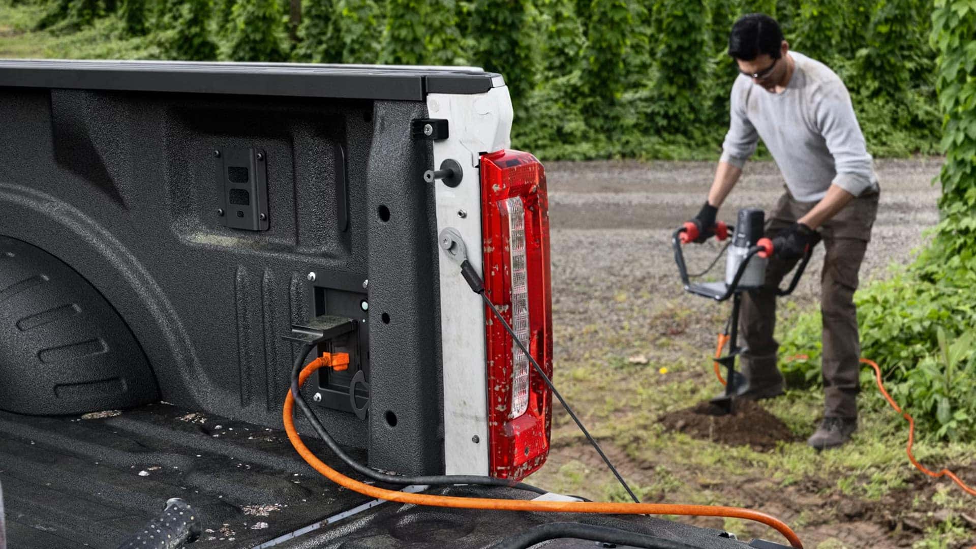 2026 Ford F-250 Super Duty Pro Power Onboard outlet in truck bed powering electric tools at a job site