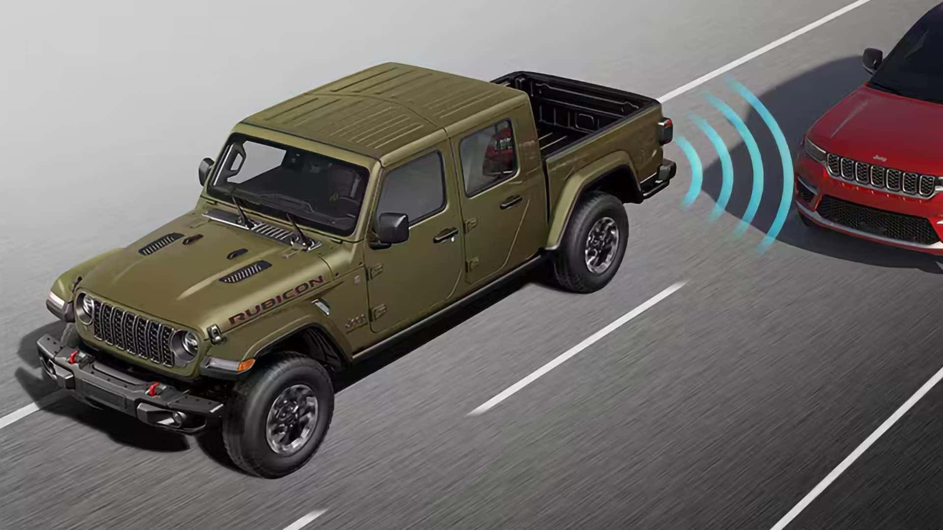 2026 Jeep Gladiator Rubicon driving on highway with Blind Spot Monitoring and Rear Cross Path Detection visualized for driver assistance