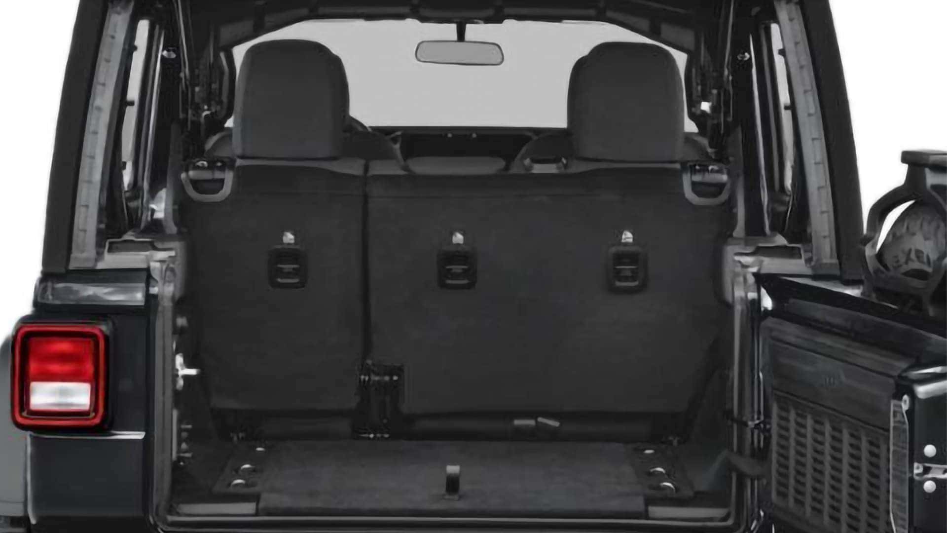 Rear cargo area of 2026 Jeep Wrangler with tailgate open and split-fold rear seats visible