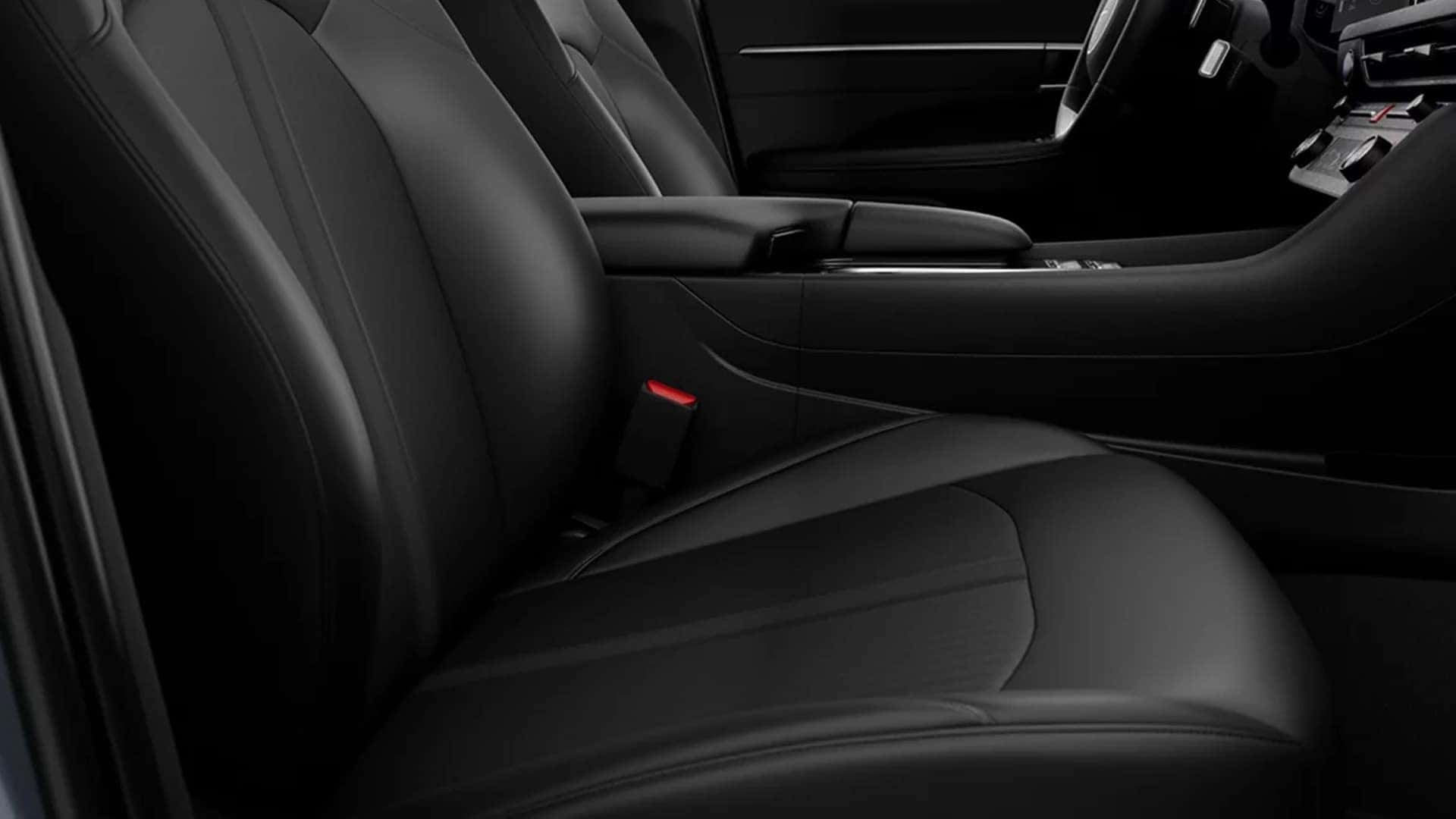 Front leather seating and center armrest inside the 2026 Hyundai Sonata Hybrid highlighting seat stitching and interior materials