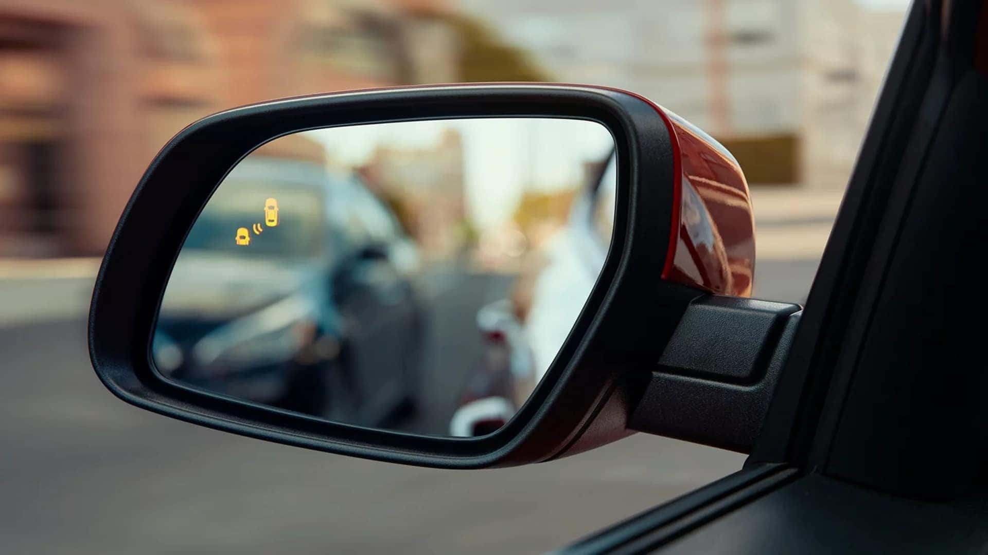 Side mirror of 2026 Hyundai Venue with blind spot warning indicator illuminated for added driver awareness.
