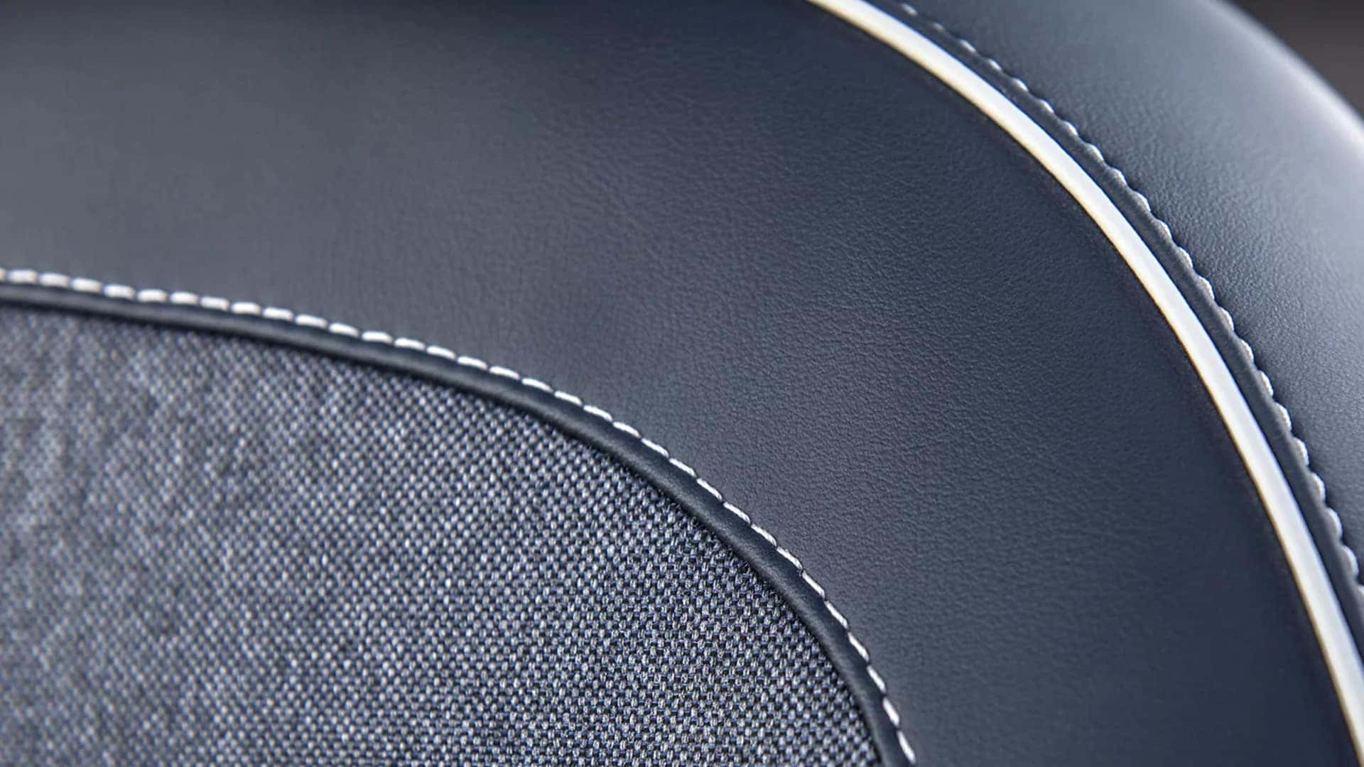Close up of 2026 Hyundai Venue interior upholstery showing stitched trim, textured fabric insert, and contrasting piping detail.