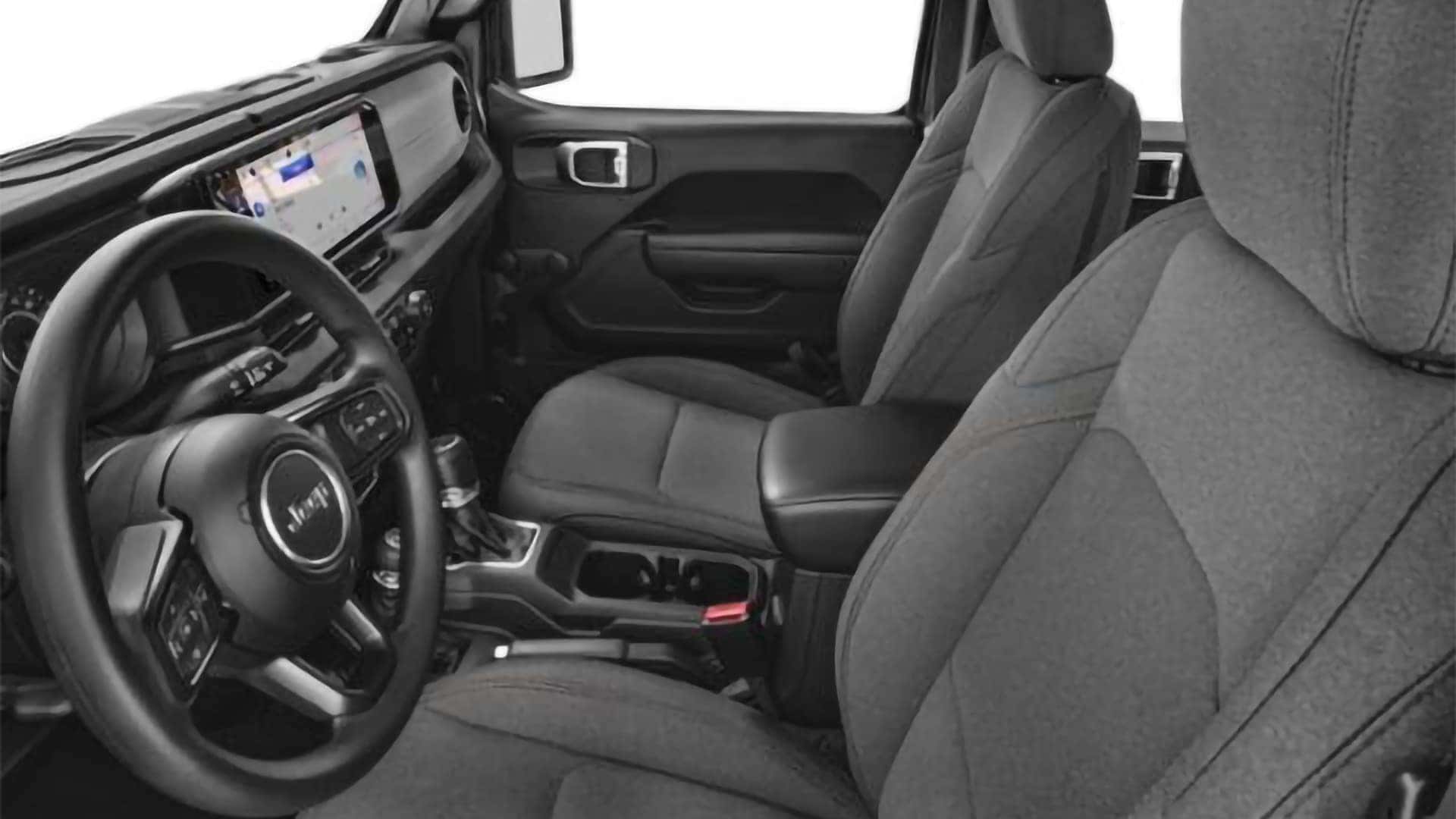 Front cloth seats and center console inside the 2026 Jeep Wrangler interior highlighting durable upholstery and stitching