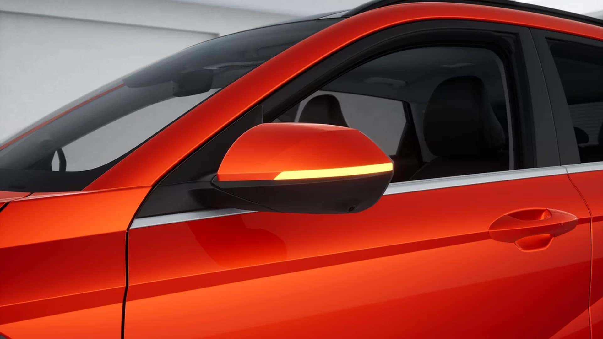 Close up of a red 2026 Hyundai Kona side mirror with integrated turn signal, highlighting exterior detail and body color finish.
