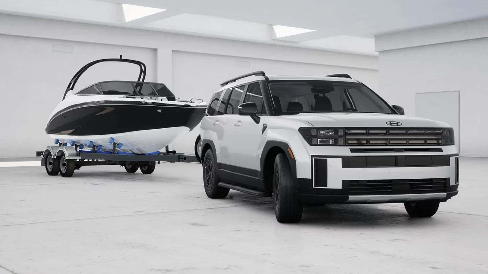 White 2026 Hyundai Santa Fe towing a boat trailer indoors, highlighting exterior size, front grille design, and towing capability.