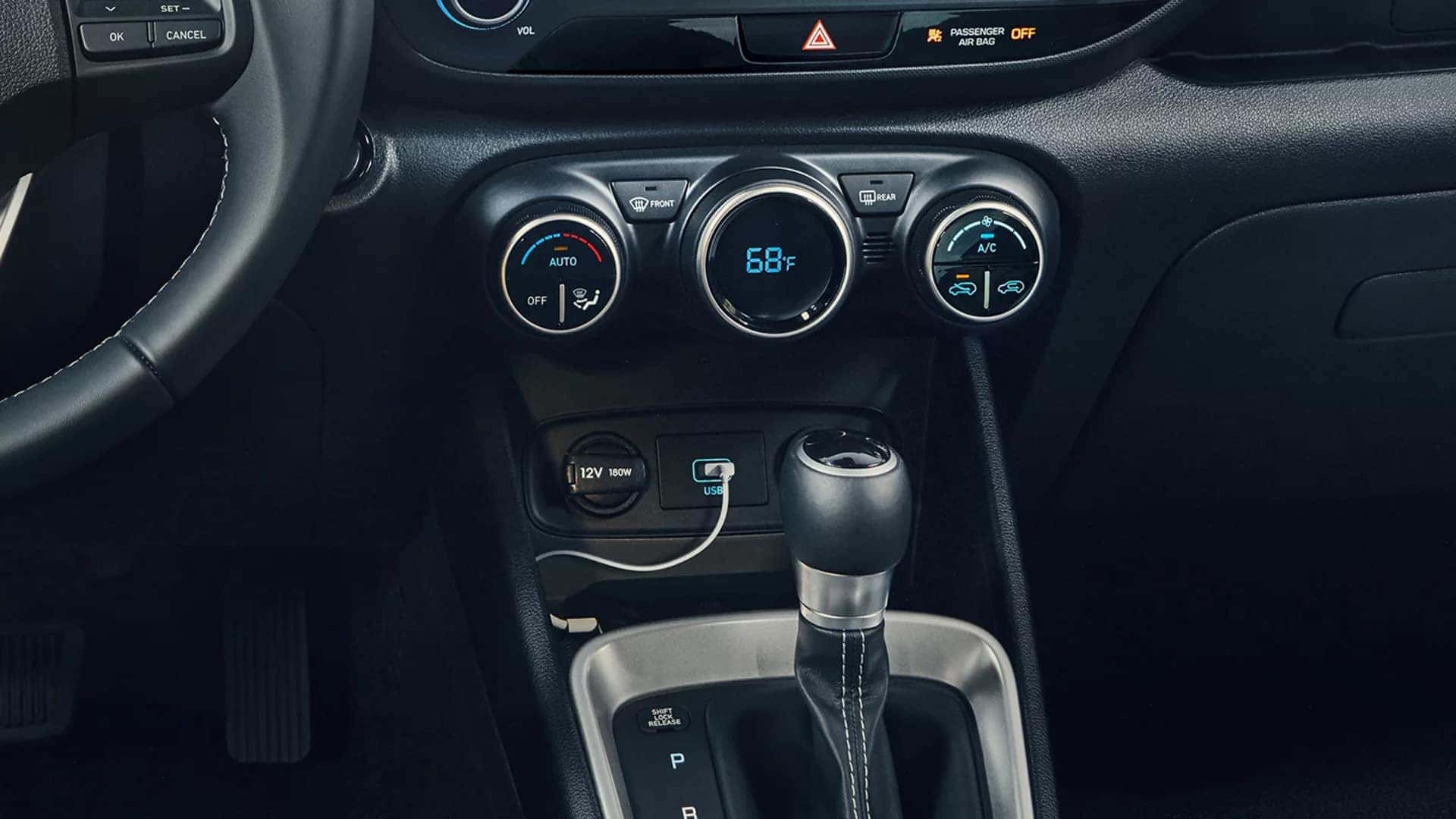 2026 Hyundai Venue center console with circular climate controls, gear shifter, USB port, and 12V power outlet.