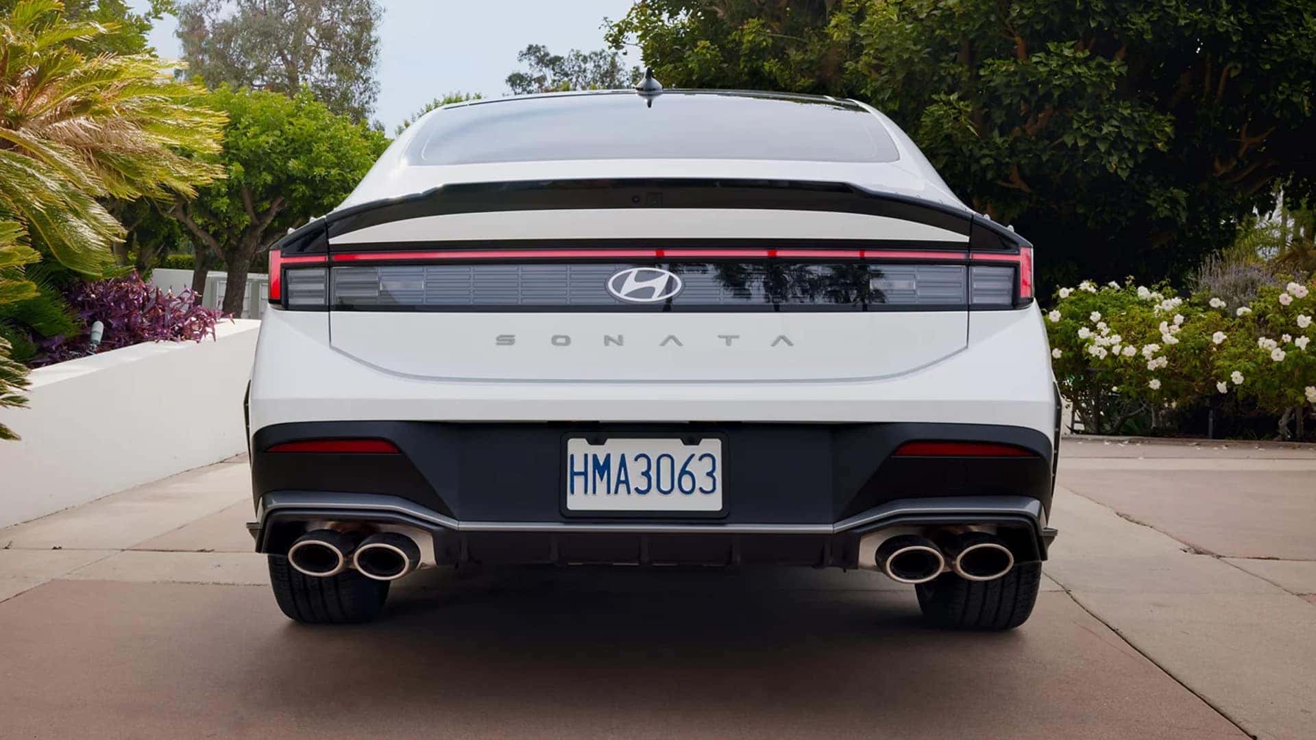Rear view of the 2026 Hyundai Sonata sedan showcasing bold taillight design, sporty rear styling, and dual exhaust outlets