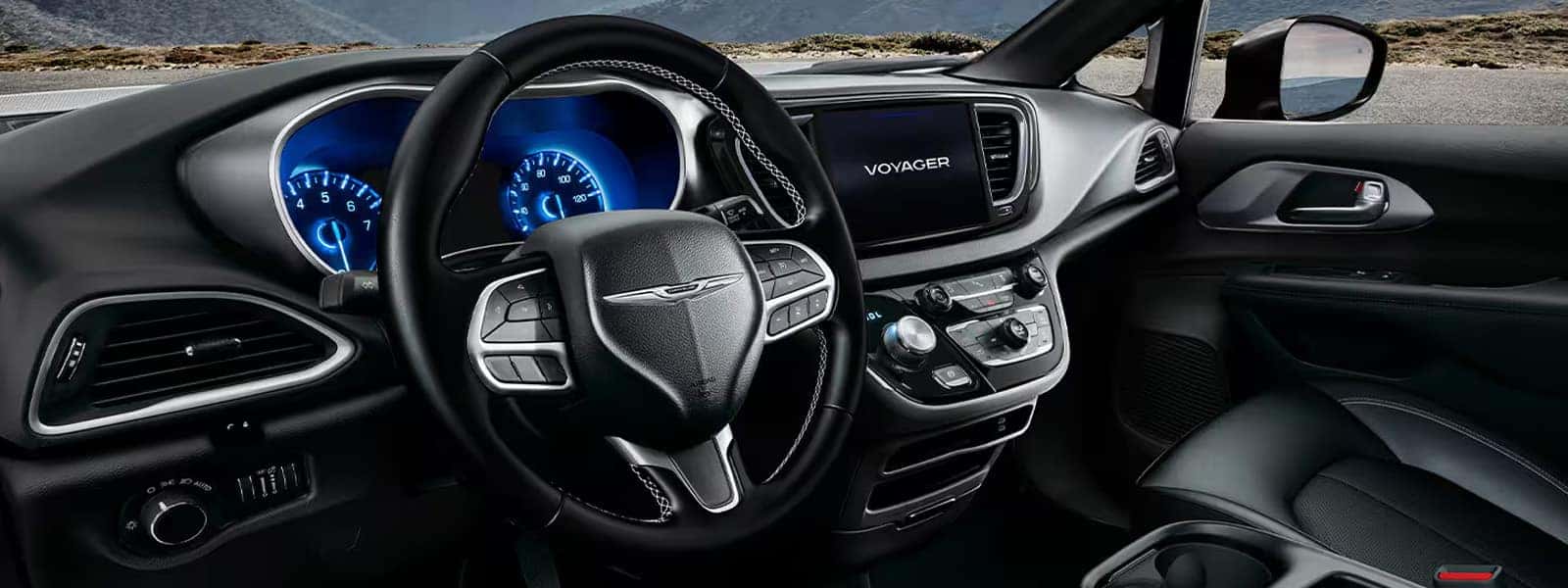 2026 Chrysler Voyager cockpit with steering wheel, instrument cluster, and center touchscreen display