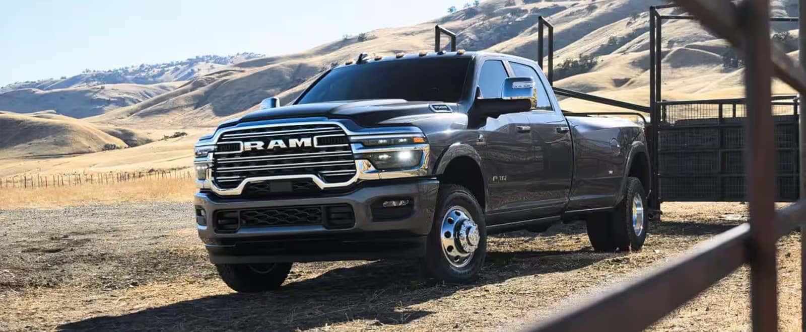 2026 Ram 3500 heavy duty truck parked on a ranch road with rolling hills in the background
