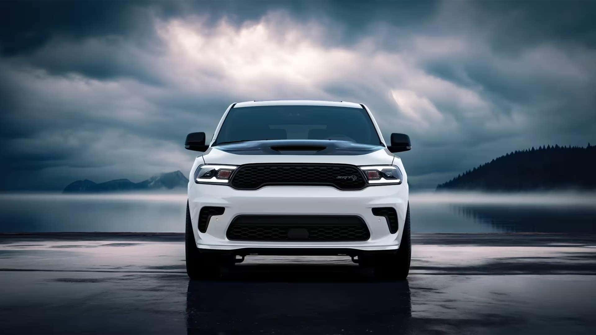 Front view of the 2026 Dodge Durango SRT Hellcat with hood scoop, black mesh grille, and wide performance-inspired front fascia