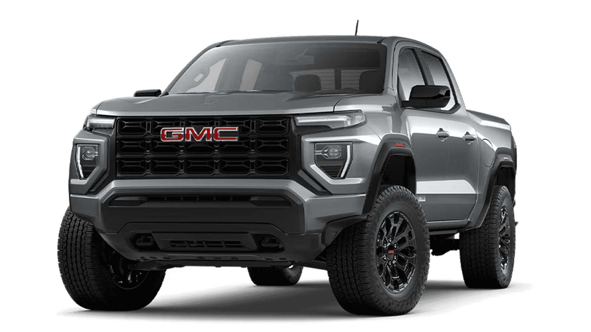 Silver GMC Canyon pickup shown in studio cutout, front three quarter view with black grille and GMC badge