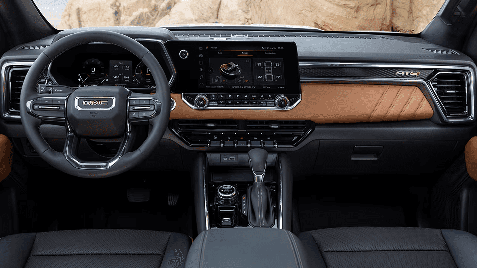 2026 GMC Canyon Denali dashboard with leather trim, wood accents, digital display cluster, and wide infotainment touchscreen
