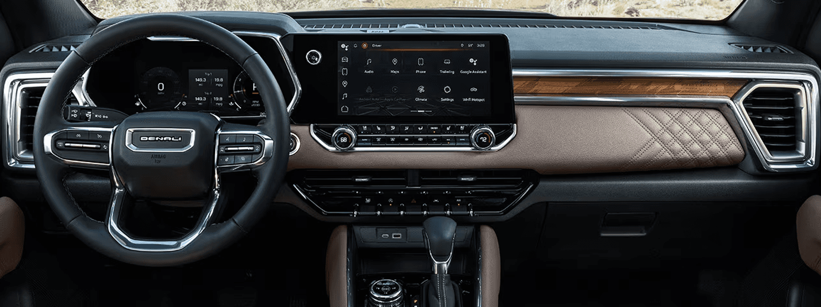 2026 GMC Canyon interior dashboard with large center touchscreen, digital driver display, and brown accent trim across the dash