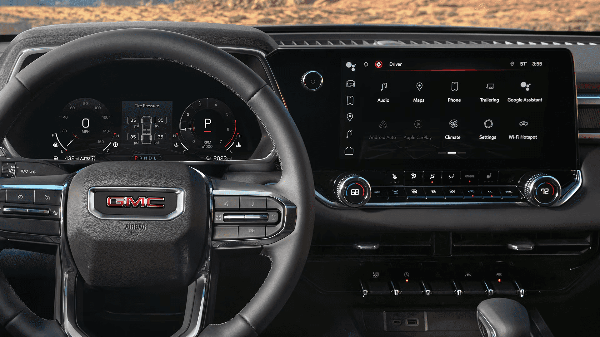 Wide interior view of the 2026 GMC Canyon dashboard with steering wheel, digital driver display, and large infotainment screen.