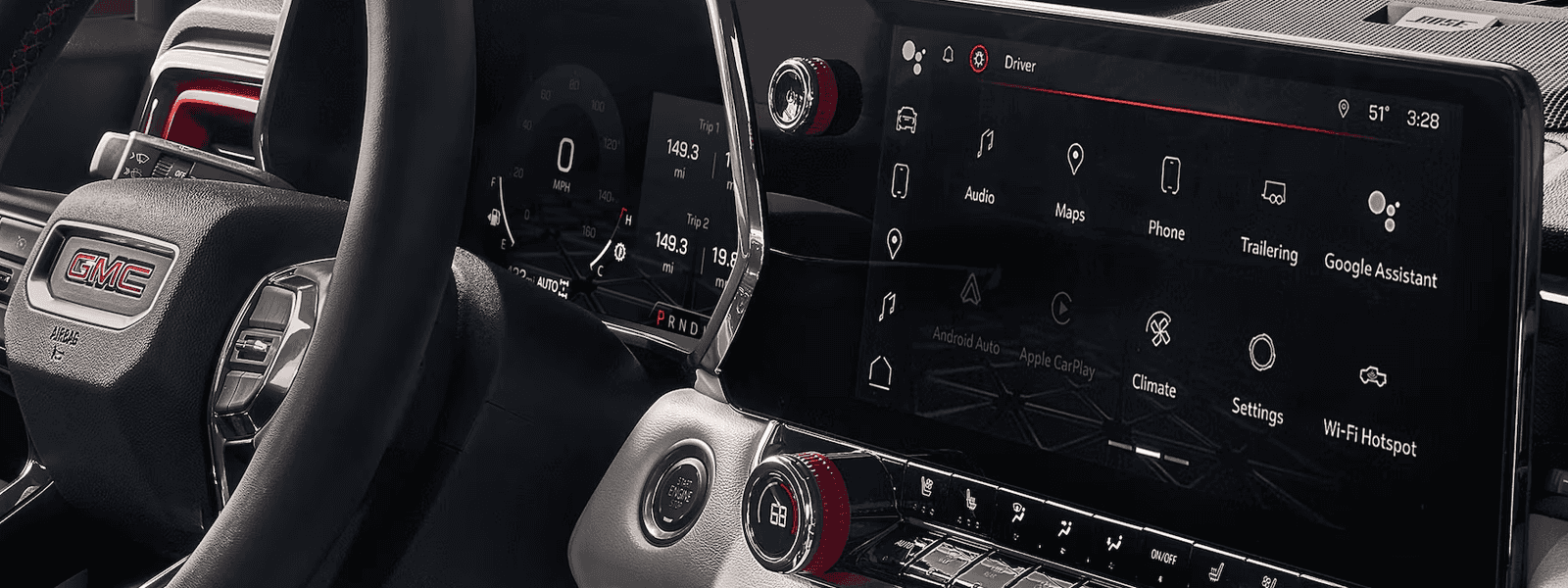 Interior cockpit of the 2026 GMC Canyon with digital driver display and wide center touchscreen infotainment system.