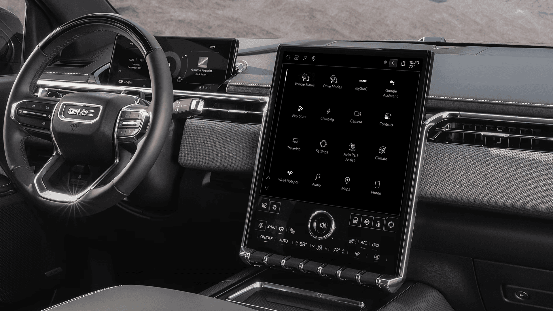 GMC steering wheel, digital driver display, and large vertical touchscreen shown on dashboard